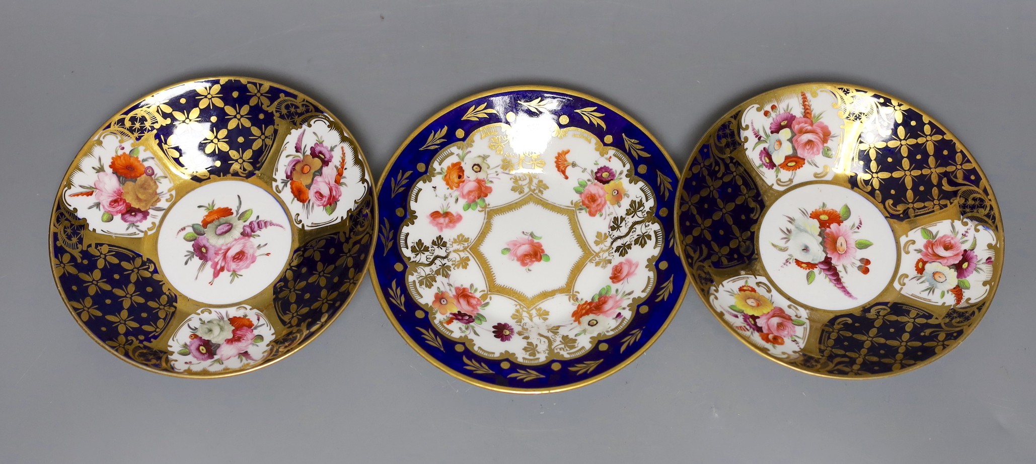 An early 19th century pair of Coalport coffee cups and saucer painted with pattern 793 and a New Hall Coffee cup, teacup and saucer, See M. Messanger, Coalport, page 168, plate 114 for pattern 793, New hall cup 6.5 cms h